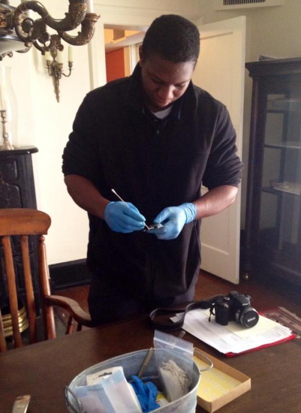 An intern from Springhill College works on a conservation project