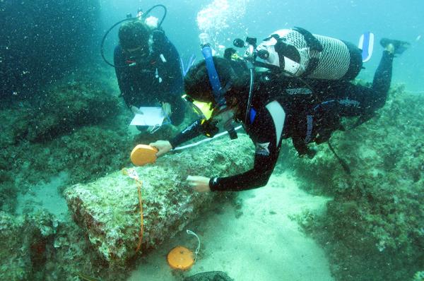 Two divers inspect part of the Marzamemi Church wreck.