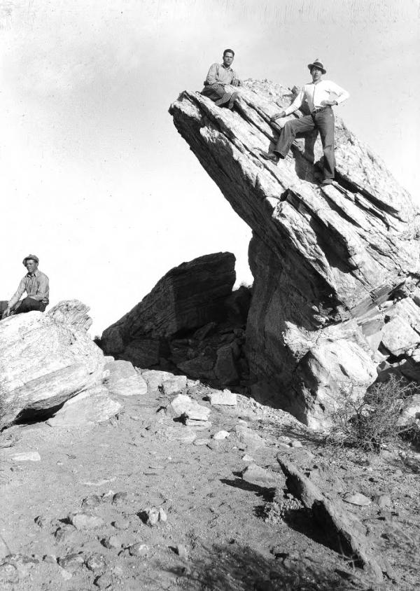 Two men climbing rock formations