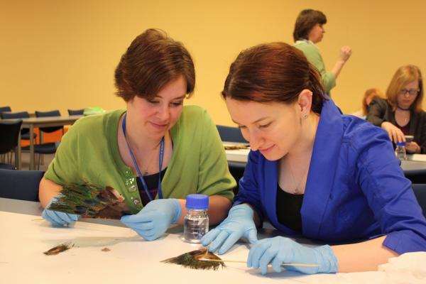 Two women at a table looking at a picture