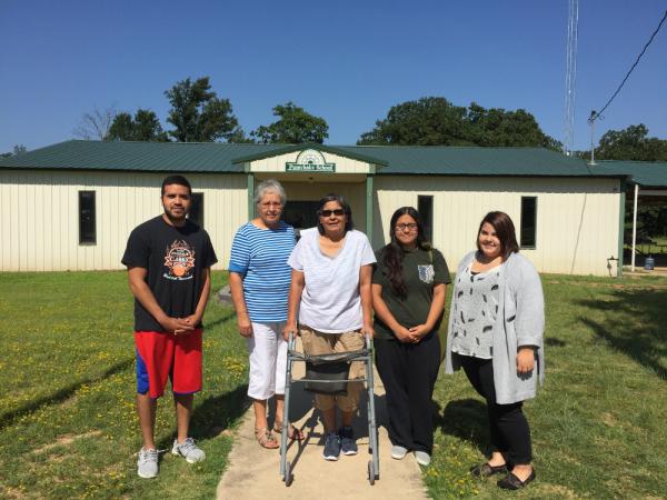 Students and speakers standing in front of the Seminole Nation's Pumvhakv School