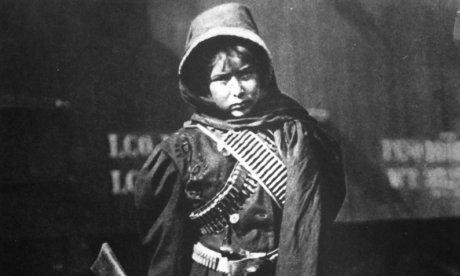 photo of boy with rifle and bandolier