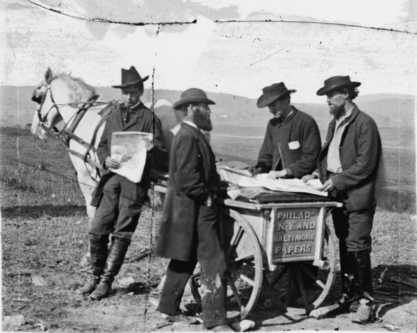 Newspaper vendor and cart in camp in Virginia, 1863