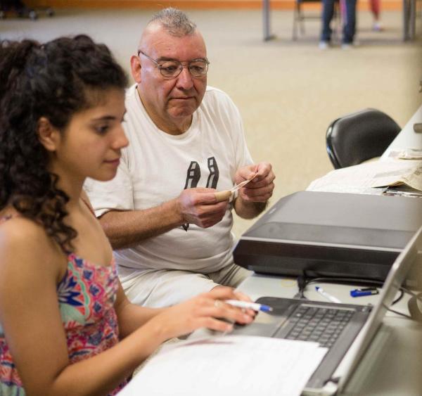 Young woman and old man at a computer