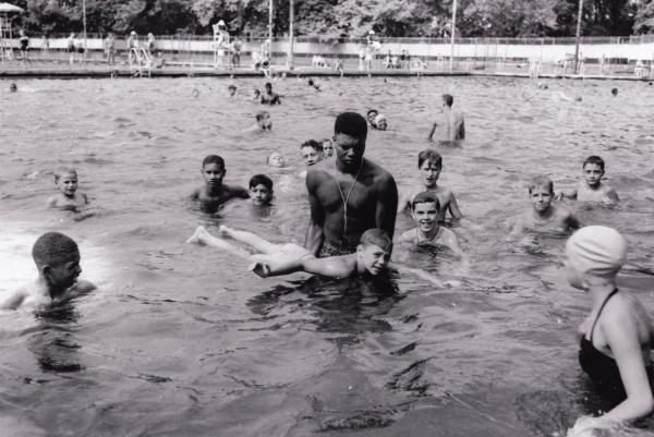 Lifeguard teaching boy to swim, Highland Park swimming pool, 1951.