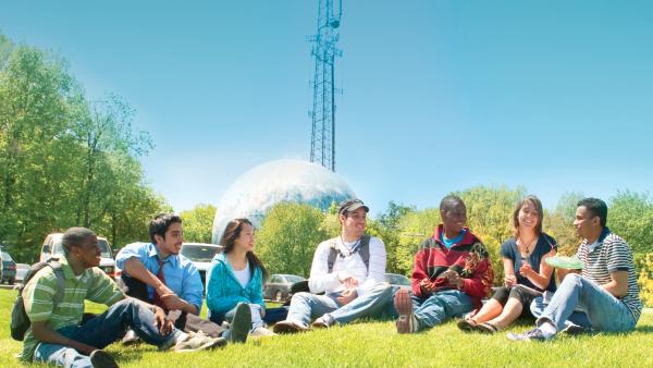Students gather by the globe water tower on the Germantown campus to discuss the global humanities.