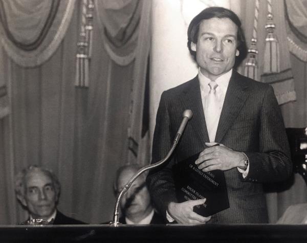 Black and white photograph of Tom Roberts receiving award.