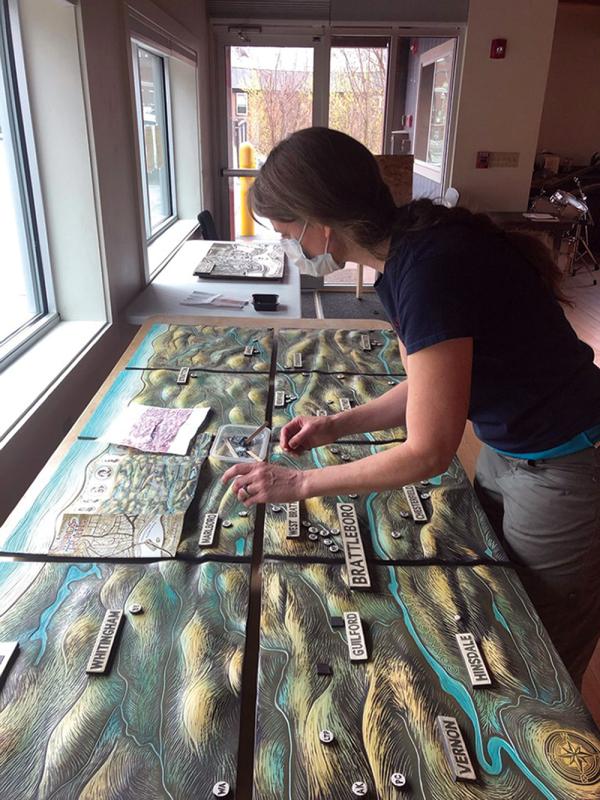 Artist Cynthia Parker-Houghton working on a mural.