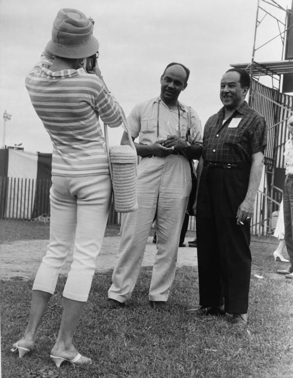 Ralph Ellison and Langston Hughes pose for a fan’s photograph at the Newport Jazz Festival, circa 1959. 