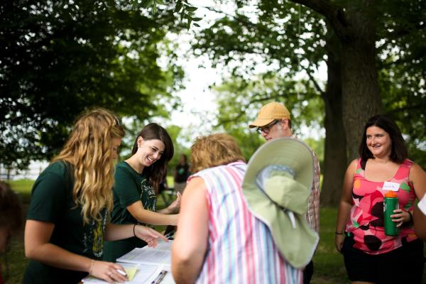 Programs and Special Projects Manager Bronwen Carlisle (second from left) checks in attendees before they embark on a paddling trip down Indianapolis's White River during a session of Indiana Humanities’ award-winning Campfires program. Courtesy of Indiana Humanities. 