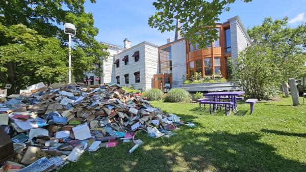 pile of books destroyed by flood water 