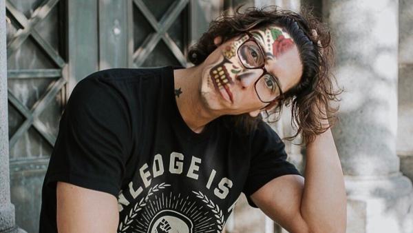 scholar Mathew Sandoval with face painted in Day of the Dead style