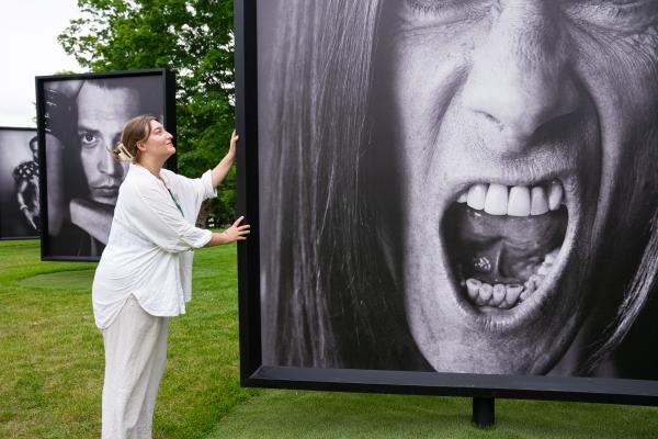 Mia Horvath during her internship at the Fenimore Art Museum in Cooperstown, showcasing a portrait from the Marc Hom: Re-Framed exhibition.