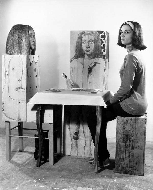 Marisol seated with her Dinner Date artwork