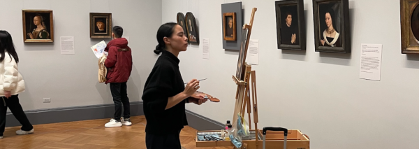 image of woman painting on canvas in museum 