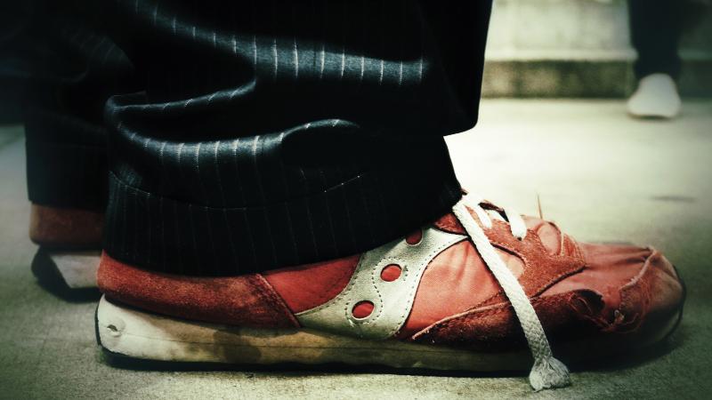 View of Garrison Keillor's shoes, red and grungy.