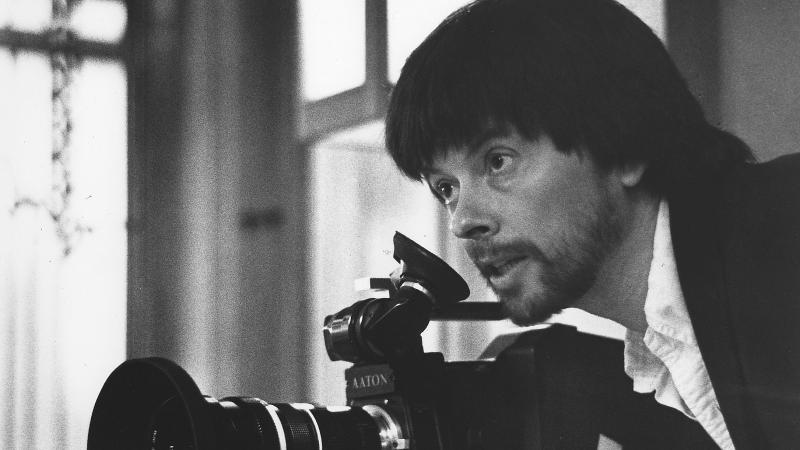 Black and white photo of Ken Burns wielding a camera.
