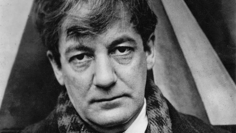 Black and white photograph of Sherwood Anderson, wearing a checkered scarf