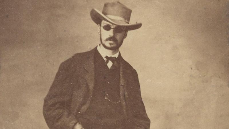 William James in 1865, wearing sunglasses and a hat