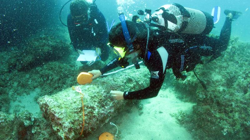 Two divers inspect part of the Marzamemi Church wreck.