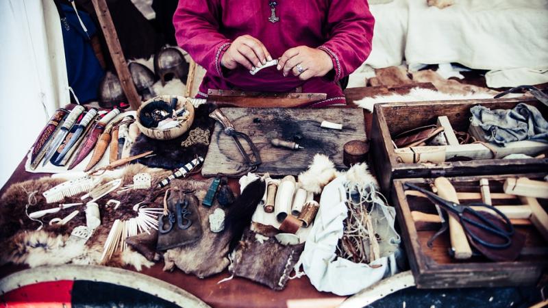 Table strewn with knives and crafted items