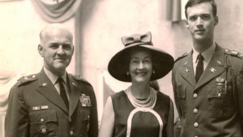 Black and white photo of three members of a family. The two men are wearing military uniforms, the sole woman wearing an elegant hat.