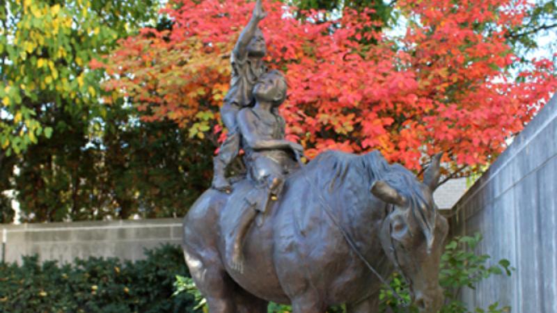 sculpture of two children on a horse