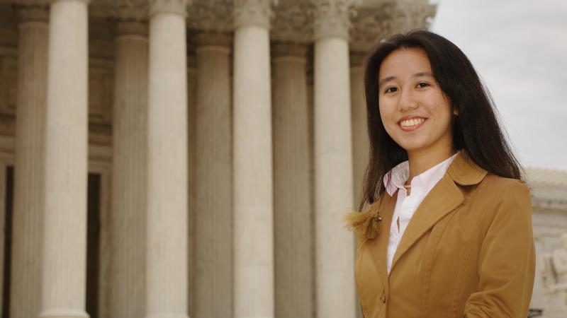 Image of young woman in front of Supreme Court building