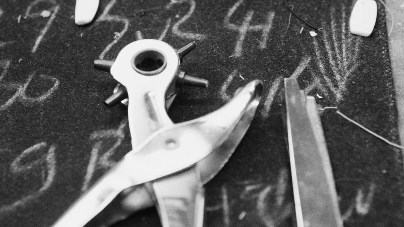 black and white photo of shearing and fabric scissors, a measuring tape