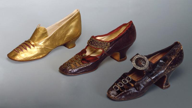 From left to right, gold shoe with a small heel and cuts across the lip, dark red shoe, and black shoe with a round buckle and high heel
