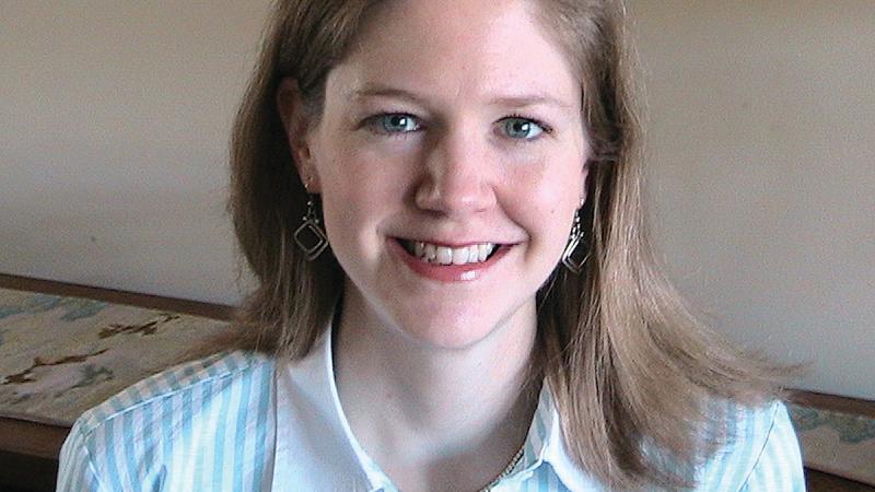 Photograph of woman in a blue shirt