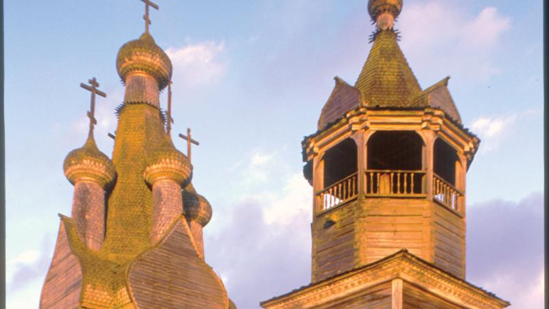 Photograph of sun setting on a church