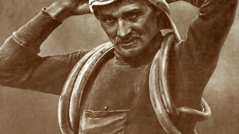 Sepia-colored photo of cyclist Francois Faber adjusting his riding goggles.