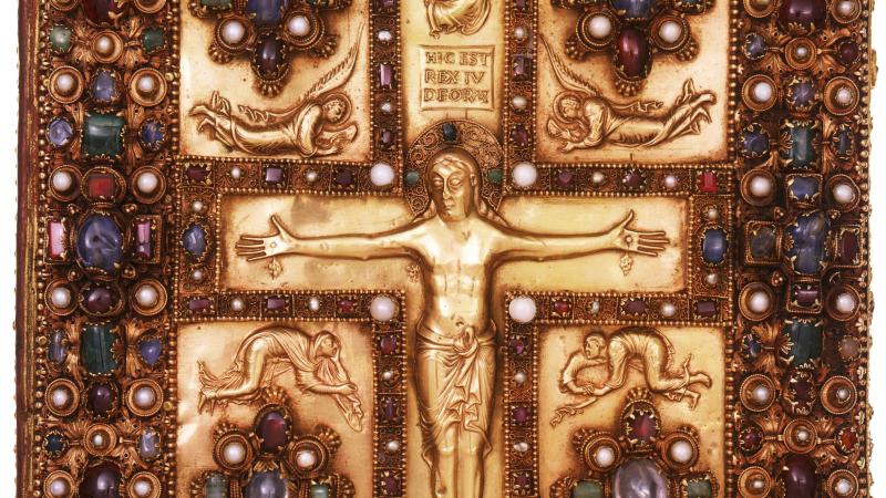 Jeweled book cover, with a design of Jesus on the cross, surrounded by angels and floral arrangements of gems