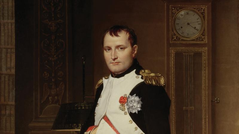 Napoleon, in full military dress, standing in his sumptuous study