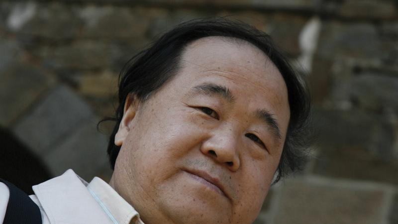 Color photo portrait of Mo Yan in a white collared shirt.