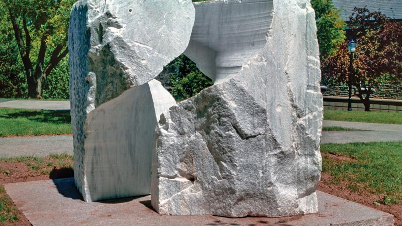 Photo of a large sculpture of marble shaped in an abstract form. 