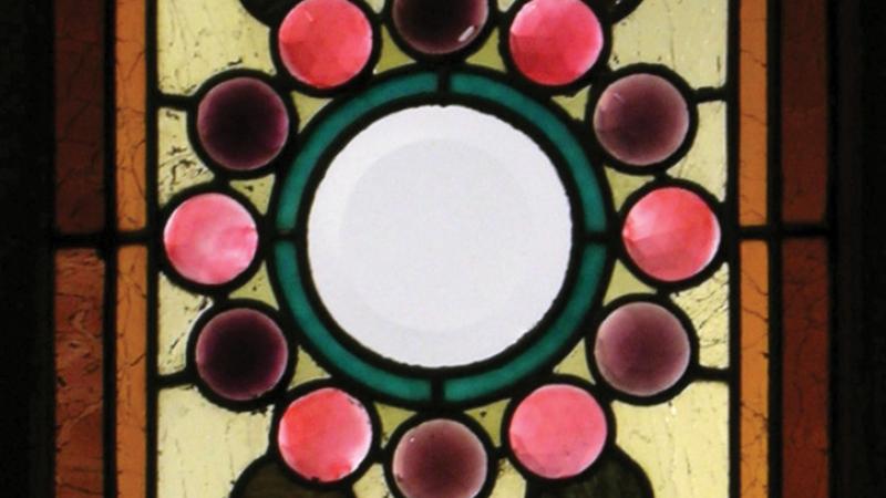 Panel of colorful stained glass in a floral pattern