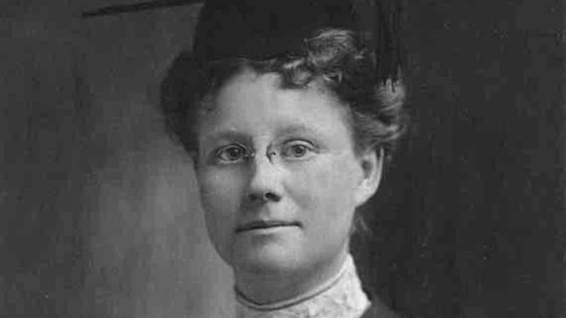 Formal portrait of Dr. Darrow, wearing a pair of small eyeglasses, black dress and lace collar