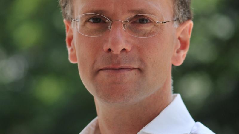 Professional photo portrait of Paul D. Halliday in a white collared shirt.