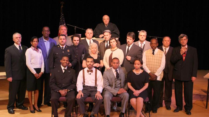 Color photo of the cast of a play.