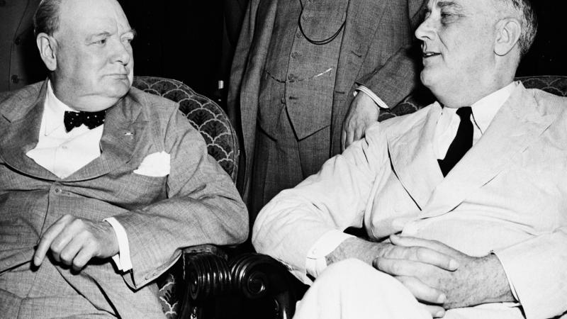 Black and white photo of Winston Churchill and Franklin D. Roosevelt sitting together.