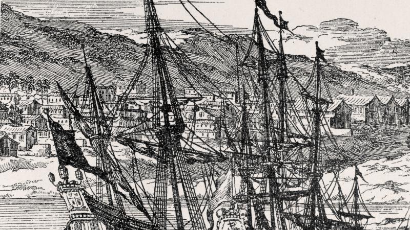 Drawing of two Spanish frigates sailing in front of a small coastal settlement. 