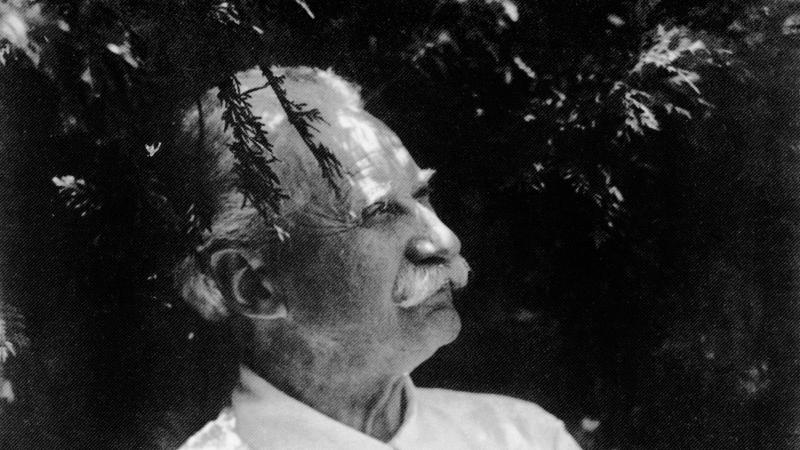 Black and white profile portrait of Jens Jensen wearing a white, short-sleeved shirt.