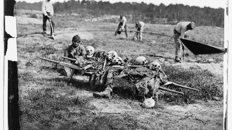 Black and white photo of African Americans carting off the bones of casualties from the Battle of Cold Harbor.