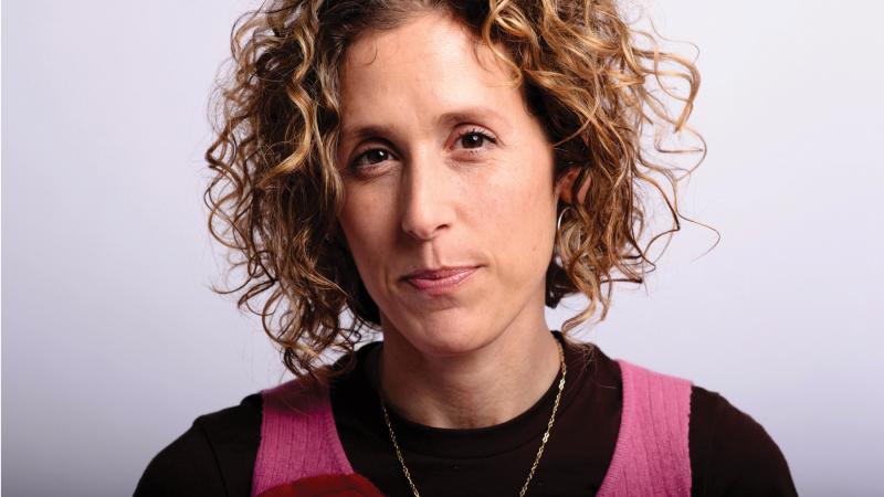 Professional photo portrait of Cara Ungar, who has curly hair.