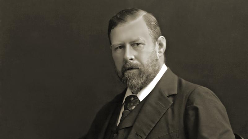 Black and white photo of Bram Stoker sitting in a chair.