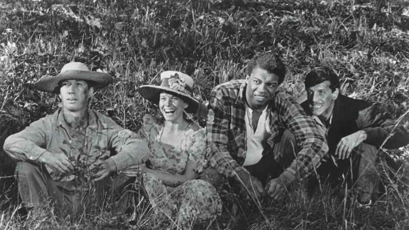 4 of Boxcar Bertha's characters, sitting a grassy field