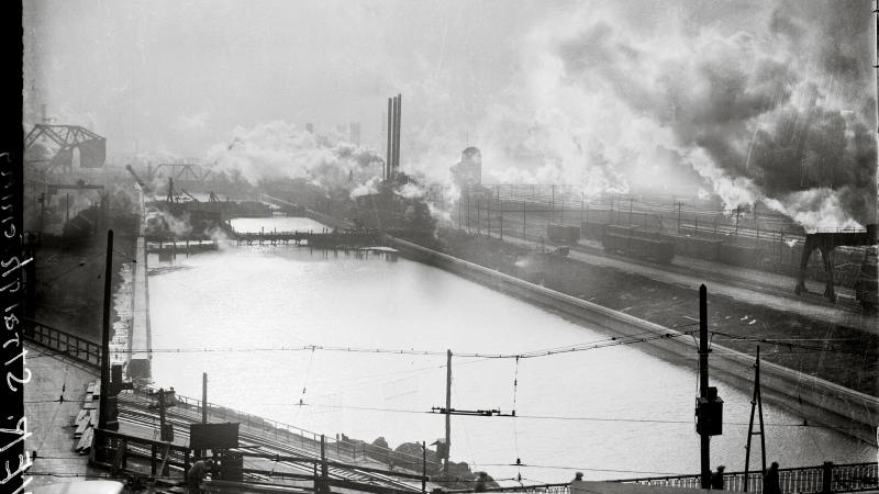 The Chicago River, surrounded by smokestacks, industrial yards and smoke