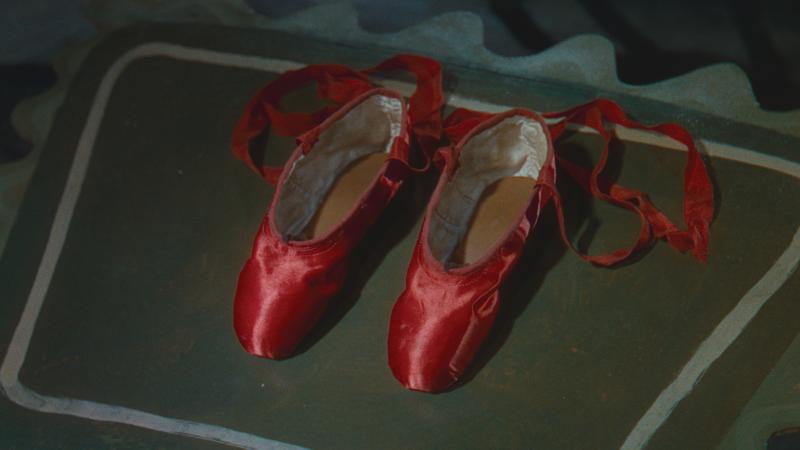 Movie still of red satin ballet shoes